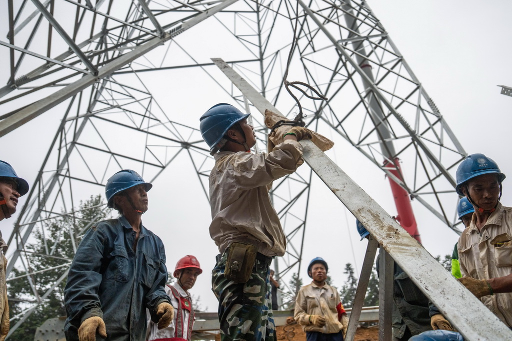 9月16日，在位于常德市桃源县的“宁电入湘”工程沅江跨越施工现场，电力工人在拼装塔材。