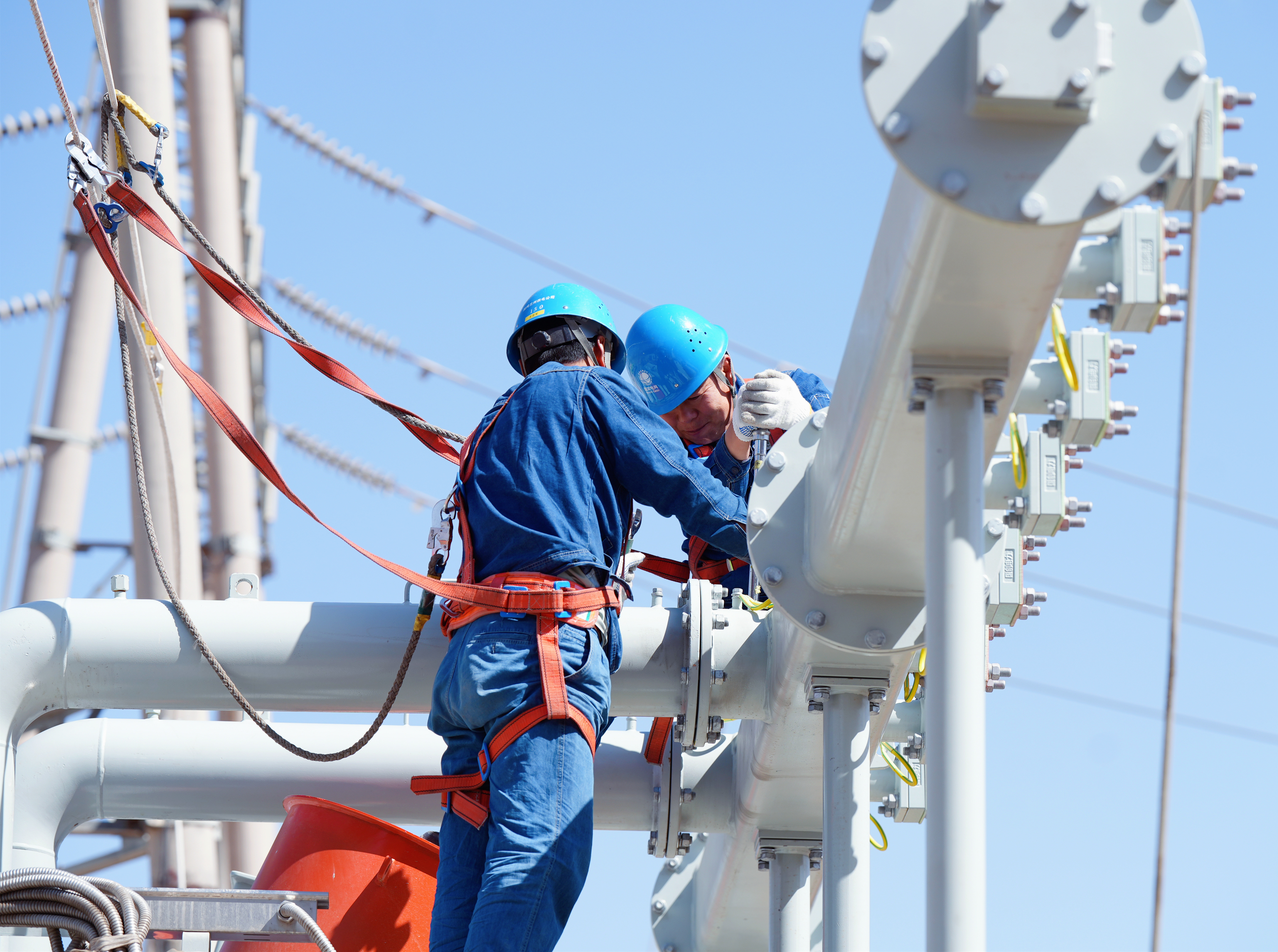 20250509国网兰州供电公司变电检修中心员工在330千伏永登变电站1号主变安装散热器主油管。史双绚摄  (2).JPG